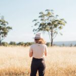 Canva – Woman standing in the middle of the farm field (1920)