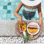 Canva-Girl-Eating-Exotic-Fruits-in-the-Pool-1920.jpg
